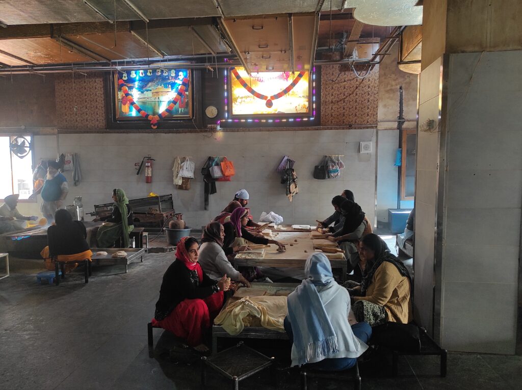 Women volunteers preparing fresh rotis in the Langar kitchen at Golden Temple, Amritsar, as part of daily seva
