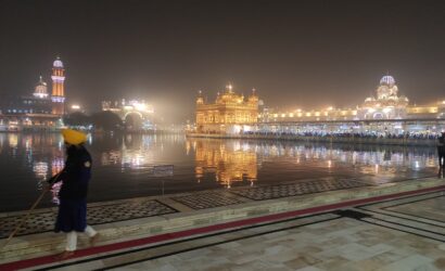 Guard standing near the sacred Sarovar at the Golden Temple, Amritsar, reflecting Sikh heritage and spiritual tranquility