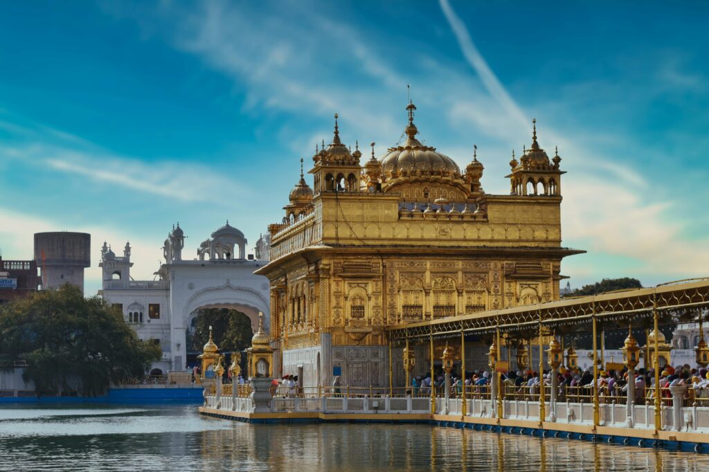Golden Temple Amritsar on a cloudy day with dramatic sky reflecting in the sacred Sarovar