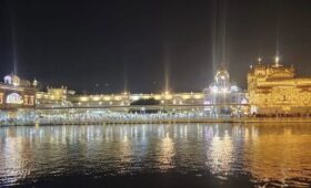 Golden Temple Amritsar illuminated at night with golden reflections on the sacred pool during a British Architecture Tour of Amritsar by E-Rickshaw or Tuk Tuk