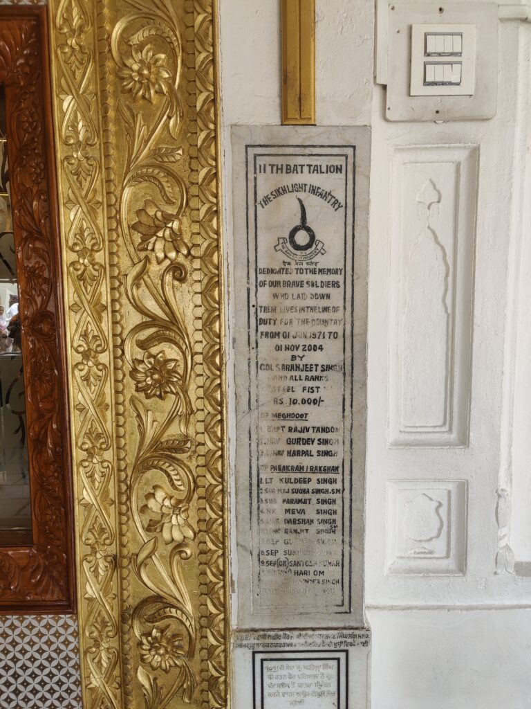 Inscribed wall at the Golden Temple displaying a historical record of donations made by members of the military.